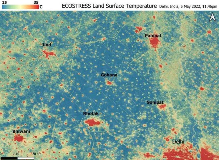 遥感图像显示，印度德里周围的村庄在图像中呈红色，比周围的蓝色和绿色地区要热得多，表明地表温度较低
